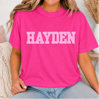 Hayden Wildcats Pink Polka Dot Top featuring a polka dot HAYDEN wordmark on a hot pink tee