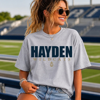 Model wearing a light gray Hayden Wildcats shirt with navy HAYDEN lettering above gold WILDCATS text and the small gold Hayden logo.