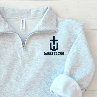 Close-up of an ash grey cadet quarter-zip with a navy pocket crest emblem and Wrestling lettering on the left chest