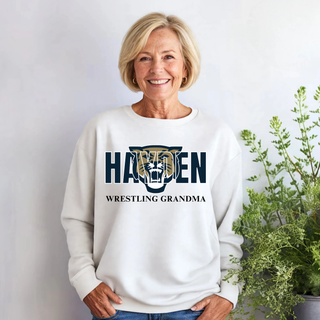 Model wearing a white crewneck with Hayden lettering, a wildcat graphic, and Wrestling Grandma text