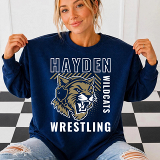 Woman wearing the Hayden Wildcats Wrestling Headgear Logo crewneck sweatshirt in navy, with white outlined Hayden lettering, a diagonal gold and navy striped bar, a gold wildcat head, vertical Wildcats lettering, and bold Wrestling text
