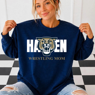 Model wearing a navy crewneck sweatshirt with a tiger graphic over HAYDEN and gold WRESTLING MOM text.