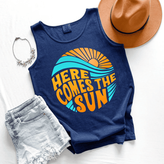Here Comes the Sun Graphic Tank in true navy with retro orange sun teal waves and bold Here Comes the Sun lettering
