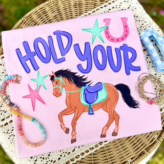 Pink tee with Hold Your Horses horseshoe and horse graphic in colorful western design
