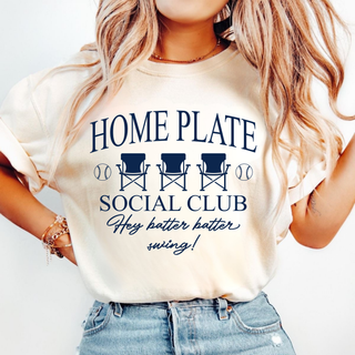 Model wearing ivory Comfort Colors tee with HOME PLATE SOCIAL CLUB Hey batter batter swing baseball chair design in navy
