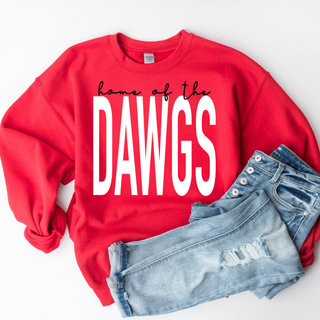 red crewneck sweatshirt flat lay featuring black script home of the text over large white block dawgs text styled with jeans
