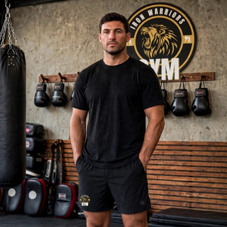 Model wearing black Barrage stretch woven training shorts with the Iron Warriors Gym logo on the leg.