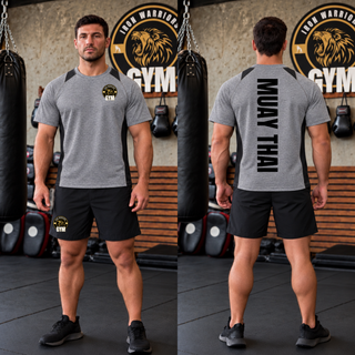 Model wearing the Iron Warriors Gym Muay Thai Lion Crest Colorblock Contender Tee, with the gym crest on the front and vertical Muay Thai lettering on the back.