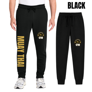 Black core fleece joggers on a model and flat, with the Iron Warriors Gym lion crest on the upper leg and Muay Thai in gold vertical lettering down the leg