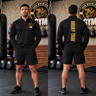 Man in a black PosiCharge quarter-zip and black shorts in a gym, shown from the front and the back with Muay Thai in gold vertical lettering