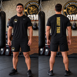 Man in a gym wearing a black rLegend tee with the gold lion crest on the chest and gold Muay Thai down the back