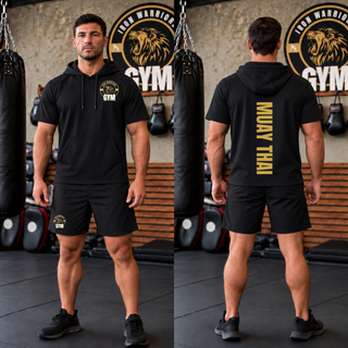 Model wearing the black Iron Warriors Gym Muay Thai Lion Crest short sleeve hooded pullover, showing the front crest and vertical Muay Thai lettering on the back.