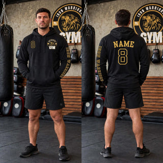 Model in a black Iron Warriors Gym Name and Number Top hoodie, gym logo and number on front, name and number on back