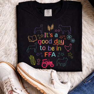 Black top with colorful farm animal and tractor icons and it's a good day to be in ag text design