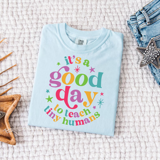 Chambray Comfort Colors tee folded flat with it's a good day to teach tiny humans colorful retro star design