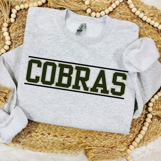 Jackson Heights Cobras Varsity Block Top, green COBRAS block lettering with a gold outline between two horizontal bars, on a heather grey crewneck sweatshirt