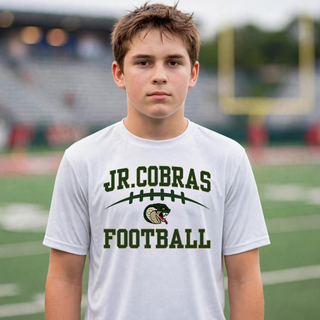 Youth model wearing a white Jackson Heights Jr. Cobras Victory Arch football top on a football field