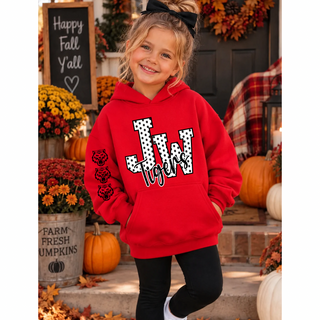 Smiling girl in a red hoodie with a white polka dot JW outlined in black, black Tigers script, and three tiger head logos down the sleeve, standing on a porch with pumpkins and mums