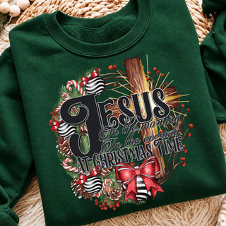 Forest green crewneck sweatshirt with a Jesus in the morning, in the evening, at Christmas time design on a wooden cross with a pine wreath, candy canes, striped ornaments, and a red bow