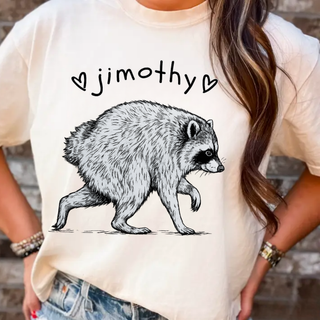 Ivory Jimothy raccoon top with sketch-style raccoon illustration and heart accents