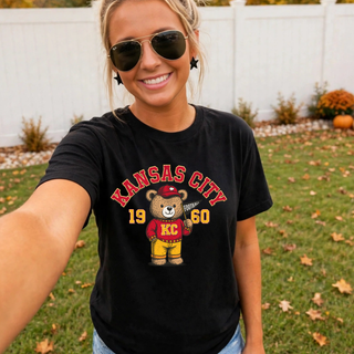 Woman wearing a black Kansas City vintage football bear top outdoors