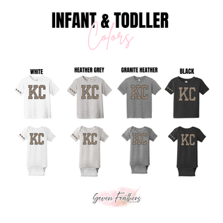Infant bodysuits and toddler tees in white, heather grey, granite heather, and black with KC lettering in leopard print and leopard print arrowheads on the sleeve