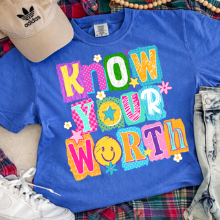 Flat lay flo blue tee with KNOW YOUR WORTH colorful daisy pop patchwork letters, smiley face, flowers, adult unisex