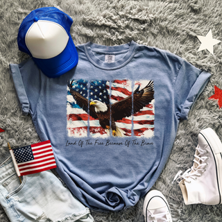 Blue jean Comfort Colors tee with land of the free bald eagle American flag graphic, blue trucker hat, white Converse
