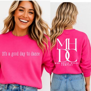 Woman wearing red crewneck with it's a good day to dance on the front and MHDC Mad House Dance Company monogram on the back