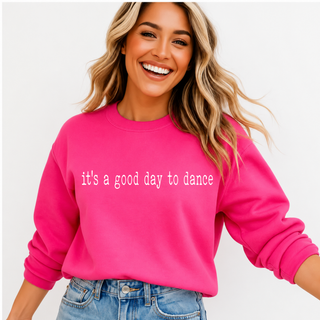 Close up of hot pink crewneck with it's a good day to dance lettering across the chest