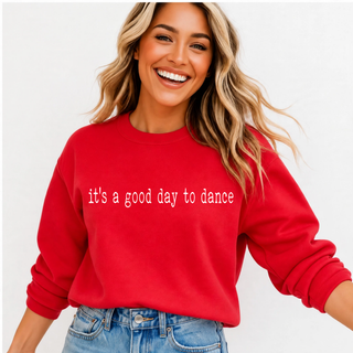 Close up of red crewneck with it's a good day to dance lettering across the chest