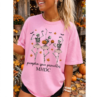 Woman wearing pink top with dancing skeleton ballerinas and pumpkin spice pirouettes MHDC design
