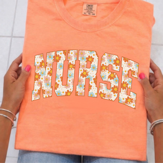 Hands holding neon cantaloupe tee with NURSE arched daisy floral print letters, retro orange blue flowers, adult unisex