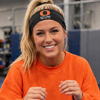 Model wearing a black Ogden's Outlaws Wrestling Club Pocket Logo PosiCharge headband