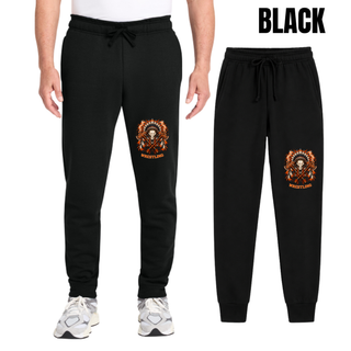 Man wearing black core fleece joggers with the Ogden's Outlaws Wrestling feathered skull and crossed axes graphic on the lower leg, next to a flat lay