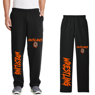 Man wearing black open-bottom fleece sweatpants beside a flat black pair, with Outlaws and a feathered skull on the thigh and large orange Wrestling lettering down the lower leg