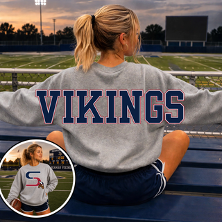 Oversized Seaman Vikings S Logo Sport Grey Crewneck back view with VIKINGS lettering, front S logo inset, on stadium bleachers