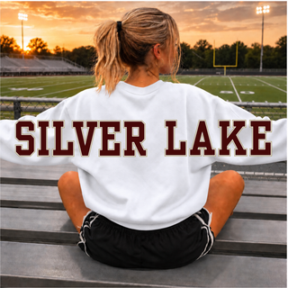 Close up of the oversized SILVER LAKE wordmark in maroon with a gold outline across the back of the white crewneck sweatshirt