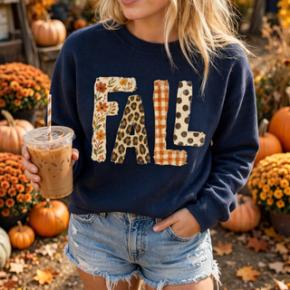 Woman wearing navy patchwork fall top with floral leopard gingham and polka dot lettering
