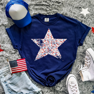 True Navy Comfort Colors tee with a large red white and blue floral star graphic styled with denim shorts and sneakers