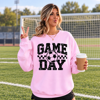 Pink crewneck with black and white checkered soccer Game Day artwork shown on a model