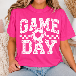Hot pink top with white and pink distressed soccer Game Day artwork shown on a model