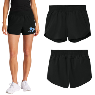 Model wearing the black Prime Athletics Baseball A's Pocket Women's Repeat Swift Short with light blue A's lettering on the left leg