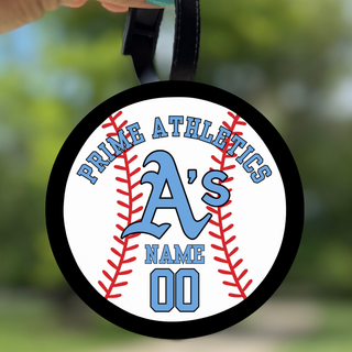 Prime Athletics Baseball Personalized Bag Tag, a round baseball-stitched tag with PRIME ATHLETICS arced above an A's logo and customizable player name and number