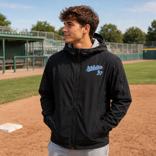 Model wearing Prime Athletics Baseball Script Logo Waterproof Insulated Jacket in Black on a baseball field