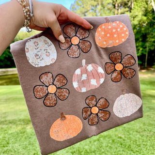 Comfort Colors espresso tee with scattered boho pumpkins and retro daisy pattern in orange, pink, and brown

