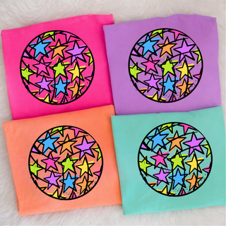 Comfort Colors Rainbow Star Volleyball graphic tee in neon pink, neon violet, neon cantaloupe, island reef flat lay
