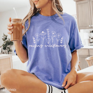 Periwinkle Comfort Colors tee with Raising Wildflowers line art floral graphic in white
