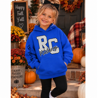 Girl in a royal blue hoodie with a white polka dot RC outlined in black, black Mustangs script, and three black mustang logos down the sleeve