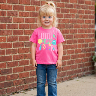 Youth XS toddler girl wearing ready to ship neon pink Little Miss Pre K t shirt with colorful smiley faces and stars standing in front of brick wall
